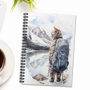 hiking cat spiral notebook at the top of white table